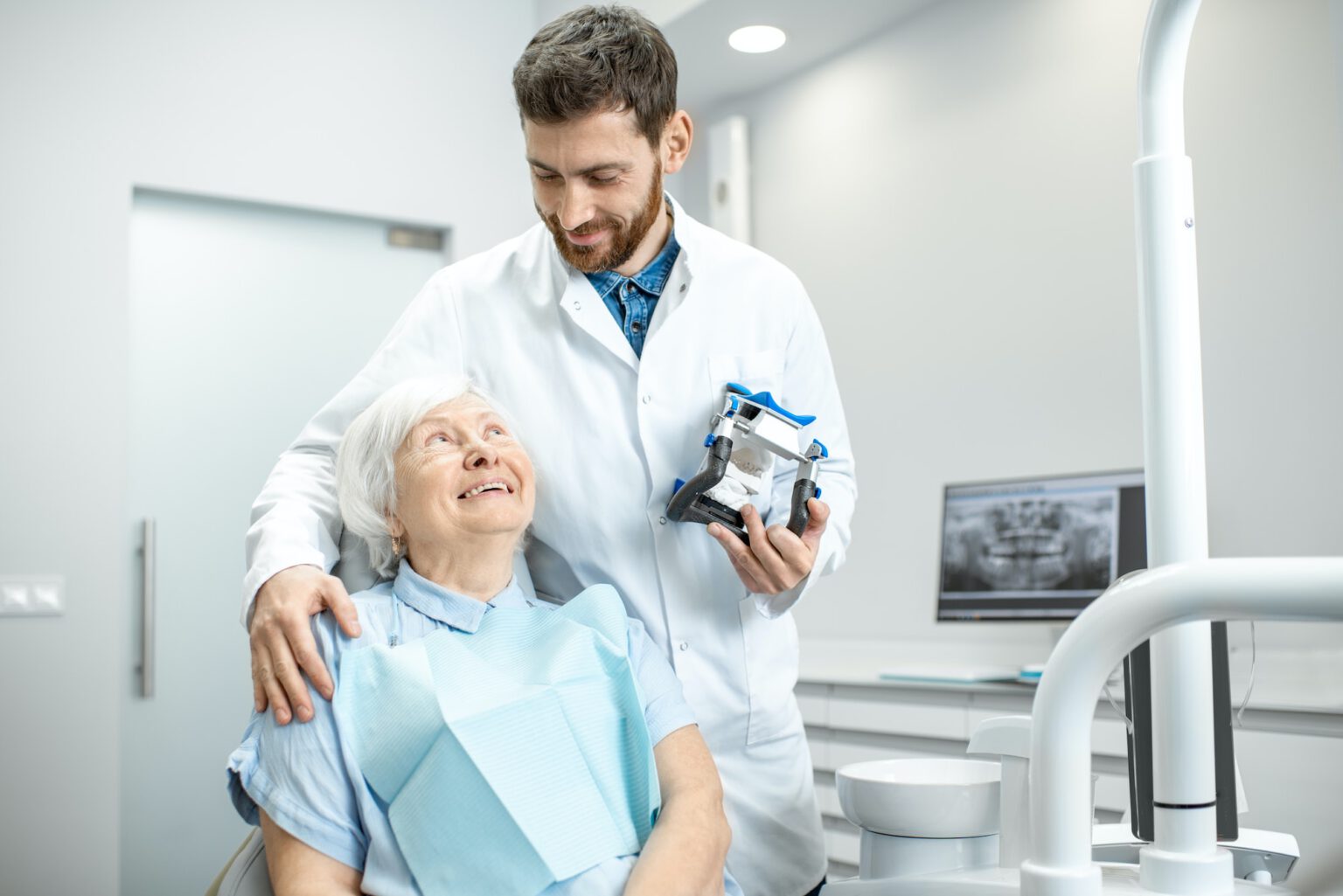 Dentist with elder woman in the dental office