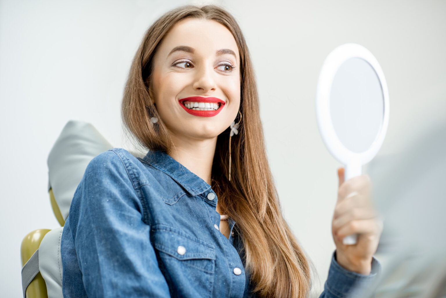 Portrait of a woman with healthy smile in the dental office